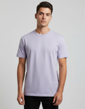 Man wearing a lavender t-shirt against a plain background