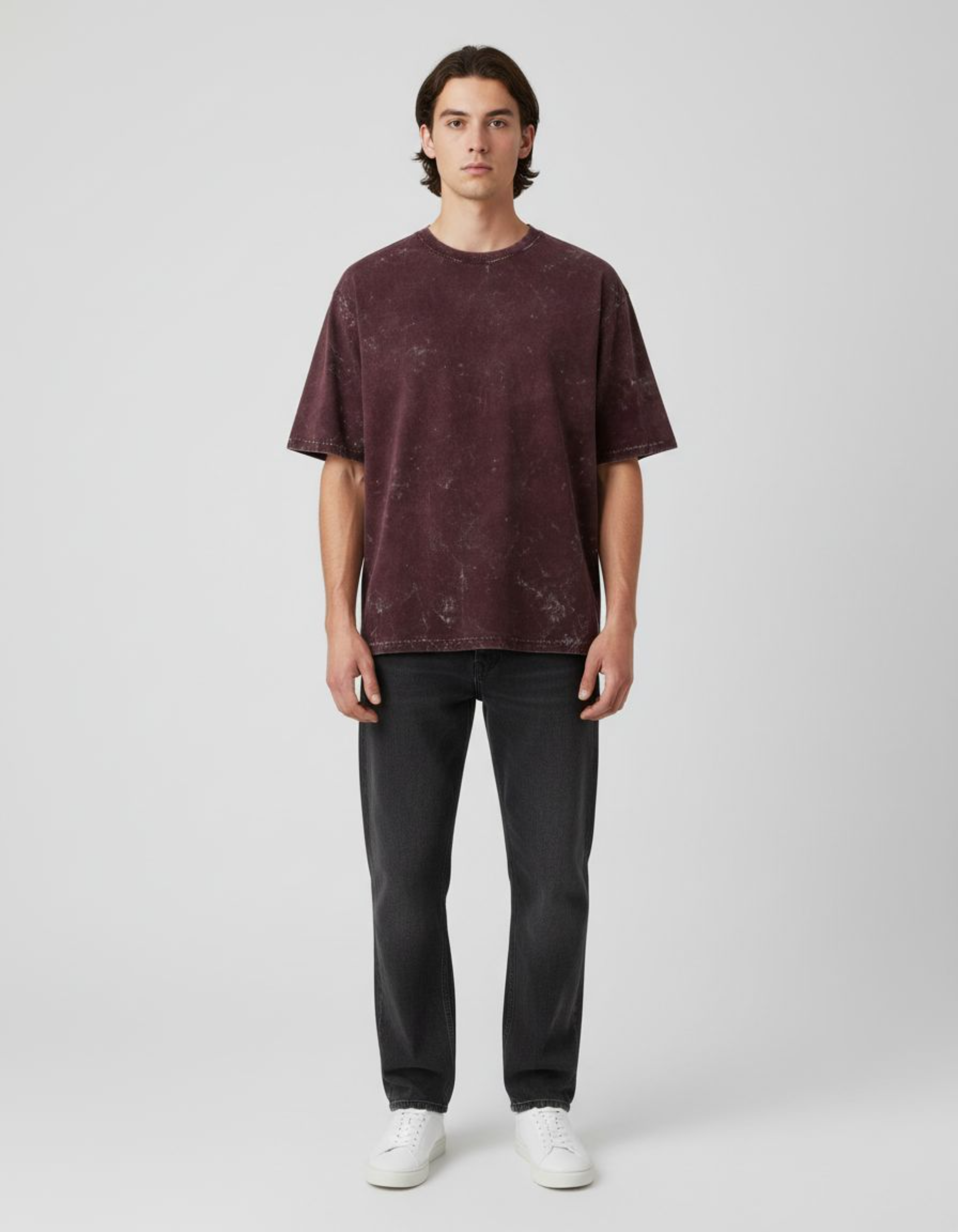 Man wearing a maroon t-shirt against a plain background