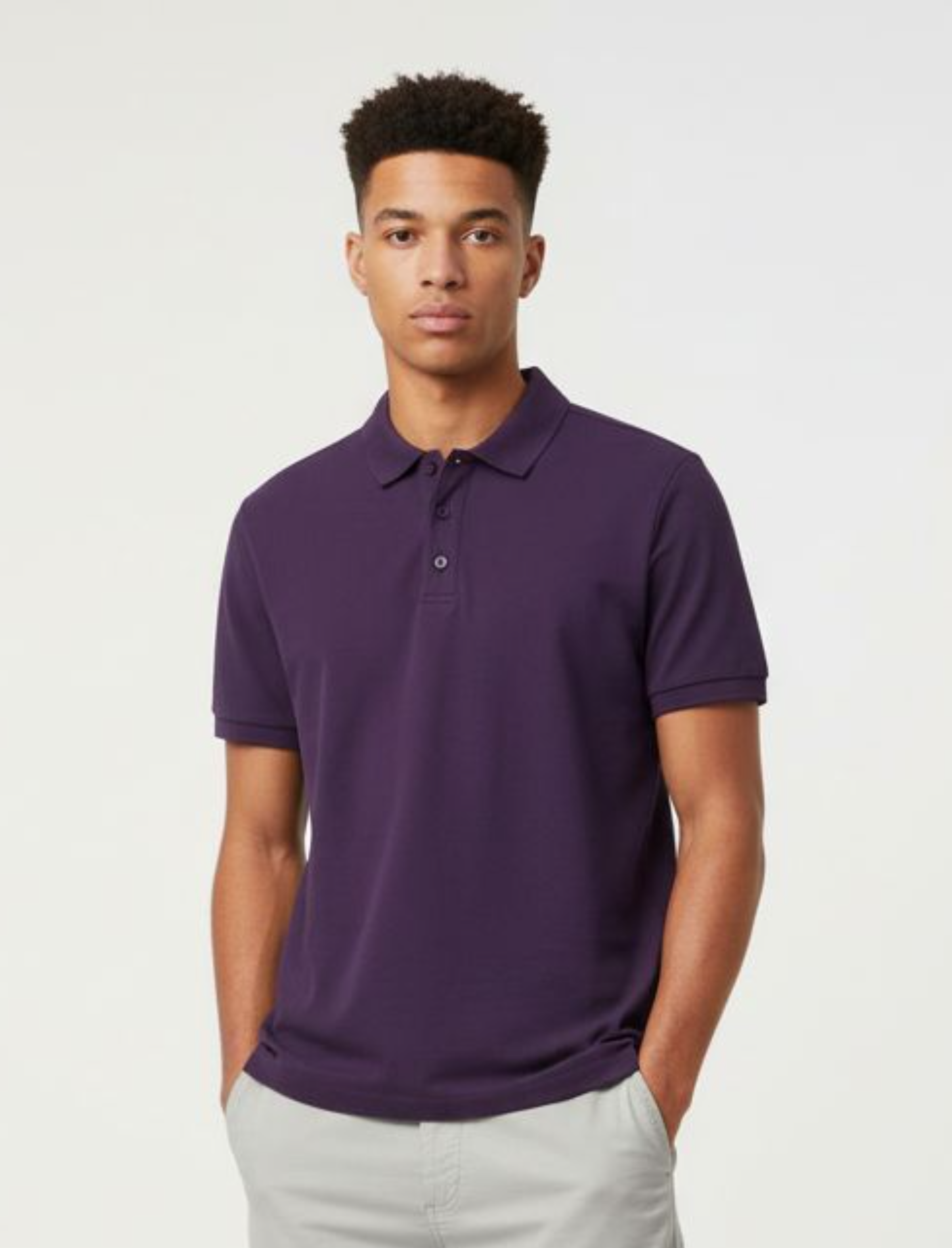 Man wearing a purple polo shirt against a plain background