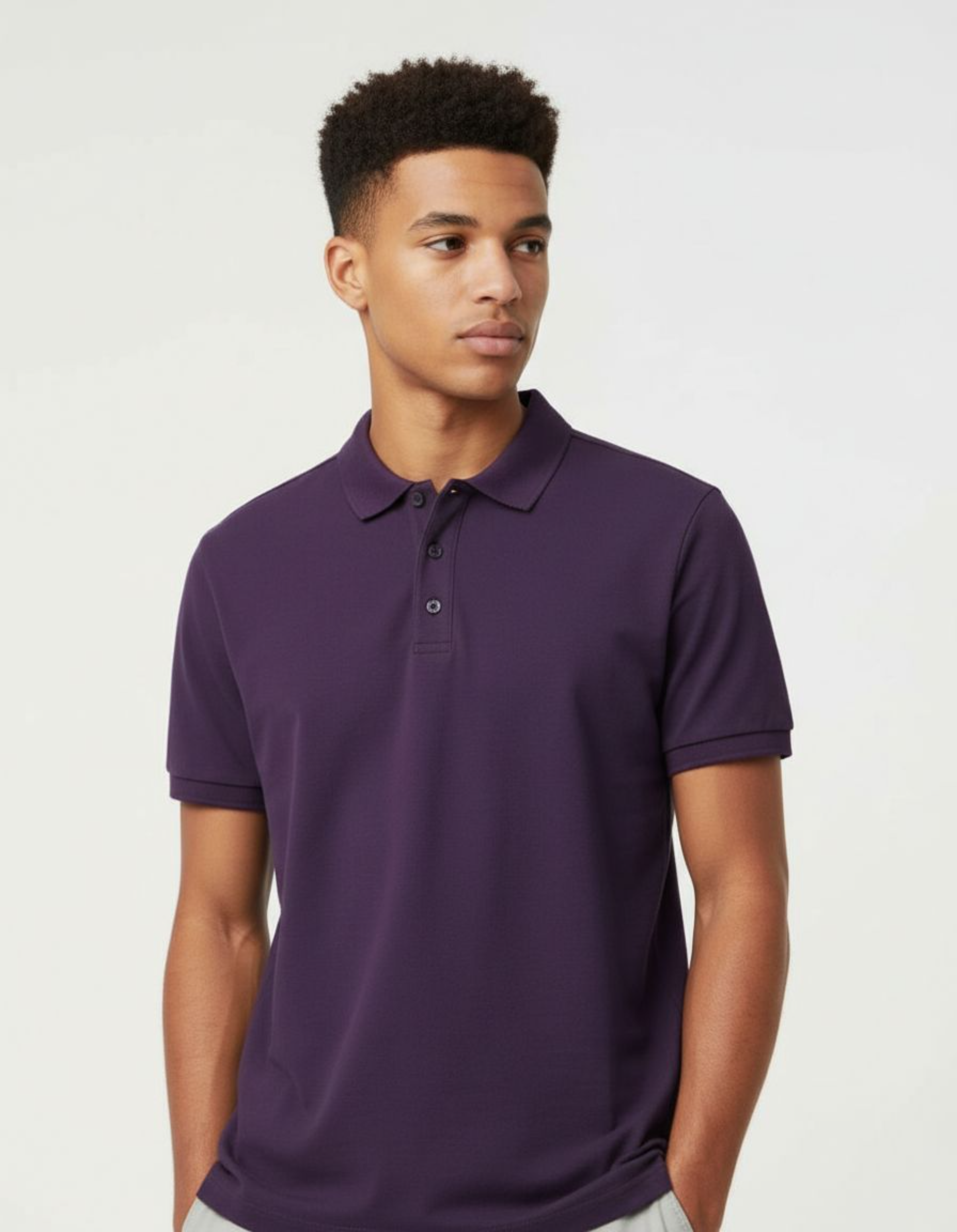 Man wearing a purple polo shirt against a plain background