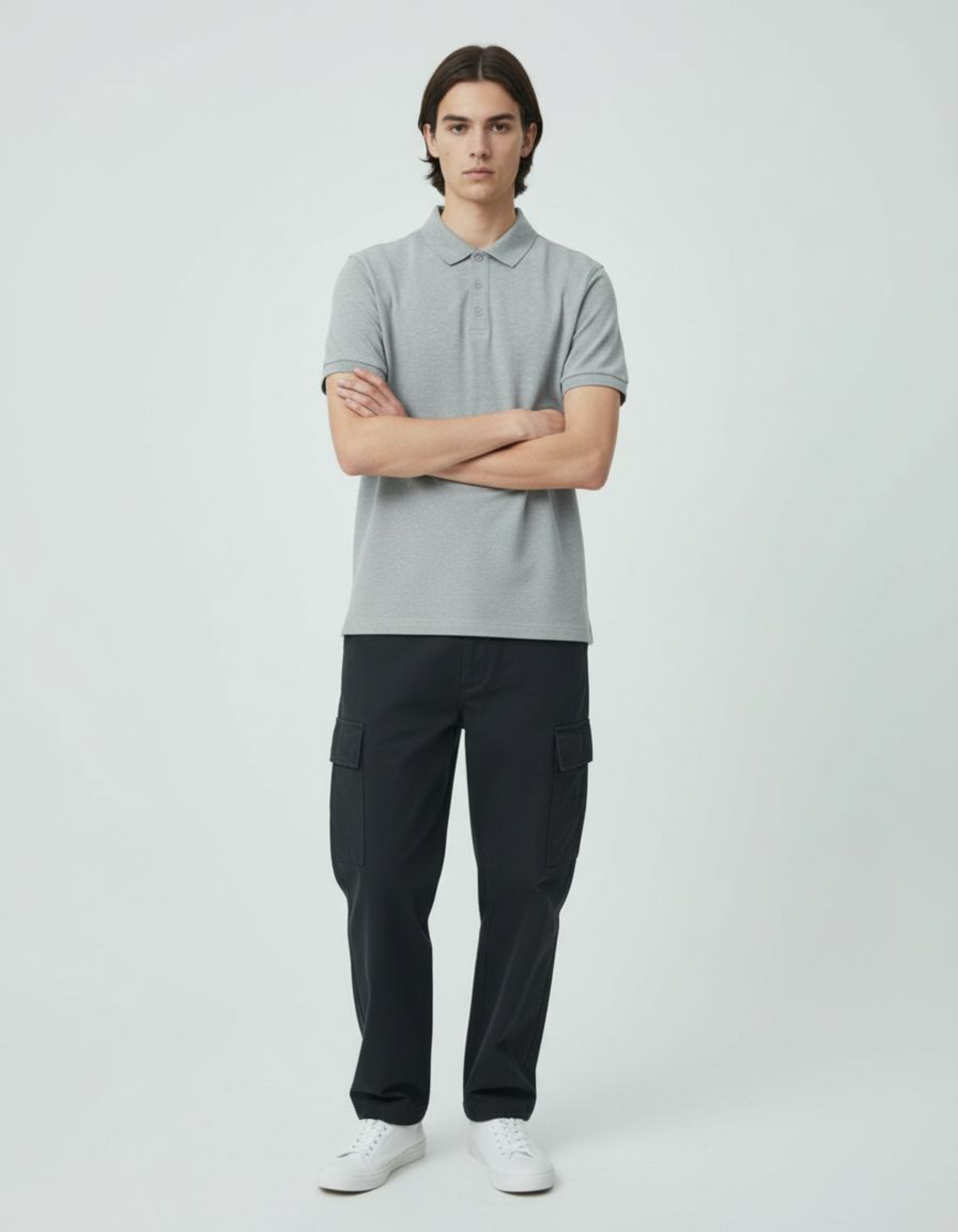Person wearing a gray polo shirt and black cargo pants on a white background