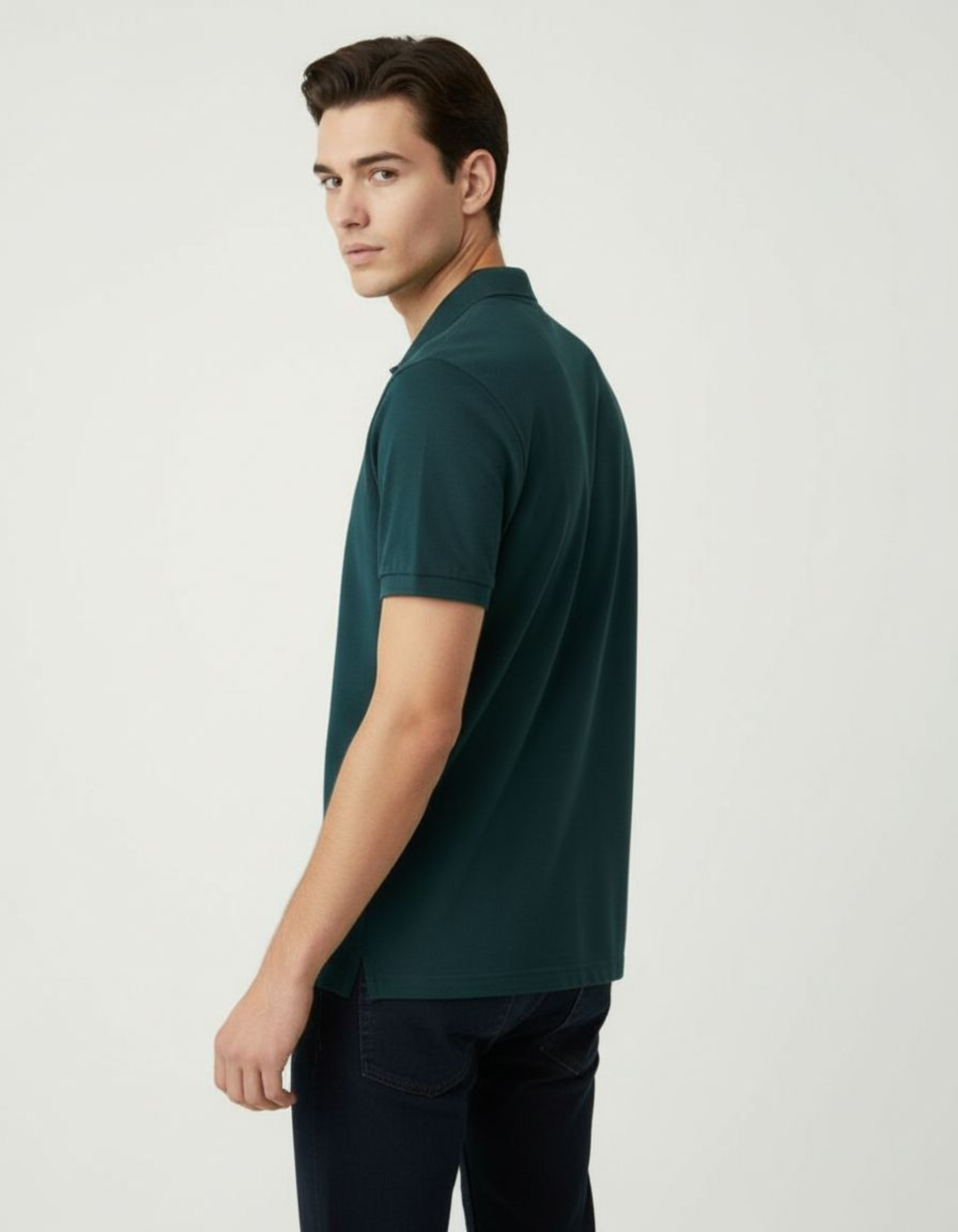 Man wearing a petrol blue polo shirt against a light gray background